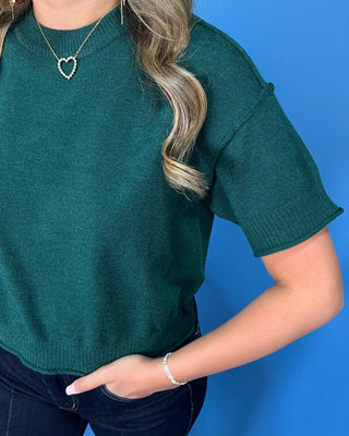 Hunter green short sleeve knit sweater top with a crew neckline, ribbed trim, and relaxed fit.