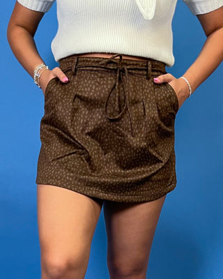 Chocolate brown suede skort with a subtle tonal print, high-rise fit, front pleating, side pockets