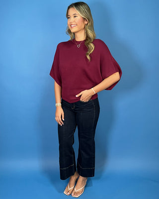Burgundy short sleeve dolman knit sweater top with a mock neckline and relaxed fit.