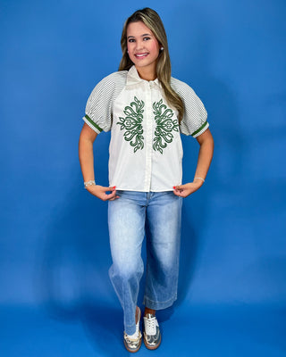 White button-up blouse with green embroidery, striped puff sleeves, and a collared neckline, shown on model.