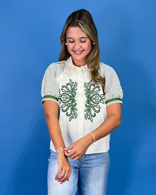 White button-up blouse with green embroidery, striped puff sleeves, and a collared neckline, shown on model.
