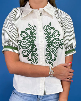 White button-up blouse with green embroidery, striped puff sleeves, and a collared neckline, shown on model.