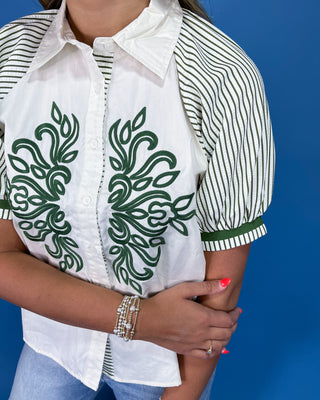 White button-up blouse with green embroidery, striped puff sleeves, and a collared neckline, shown on model.
