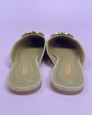 Pair of sandals with 'SODA' branding on a light purple background