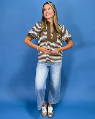 Brown and cream striped top with contrast collar, split neckline, and puff sleeves, shown on model.