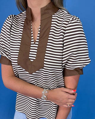 Brown and cream striped top with contrast collar, split neckline, and puff sleeves, shown on model.