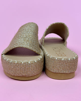 Pair of sandals with jute sole on a pink background