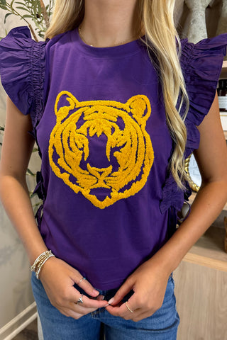 Person wearing a purple shirt with a yellow tiger design