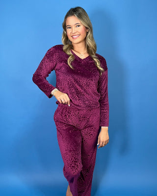 Burgundy velvet animal print lounge set with a V-neck long sleeve top and matching relaxed-fit pants.