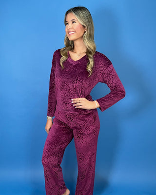 Burgundy velvet animal print lounge set with a V-neck long sleeve top and matching relaxed-fit pants.