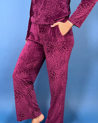 Burgundy velvet animal print lounge set with a V-neck long sleeve top and matching relaxed-fit pants.