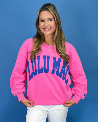 Woman wearing a sweatshirt with text against a blue background