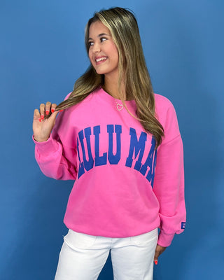 Woman wearing a sweatshirt with text against a blue background