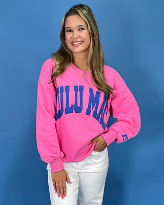 Woman wearing a sweatshirt with text against a blue background