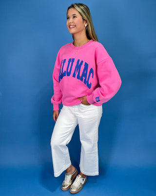Woman wearing a sweatshirt with text against a blue background