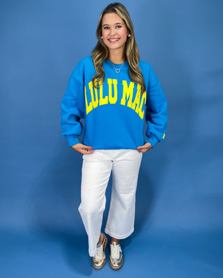 Woman wearing a sweatshirt with text against a blue background