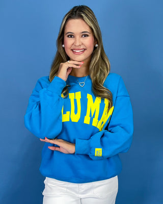 Woman wearing a sweatshirt with text against a blue background