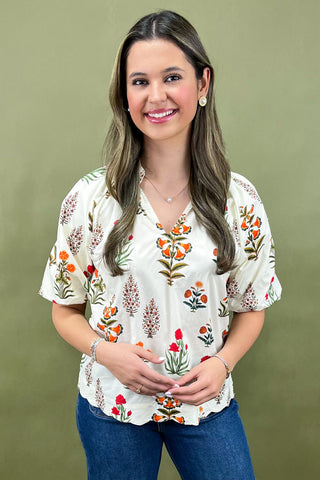 Woman wearing a floral blouse with a green background
