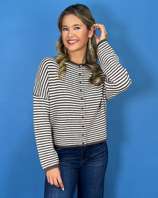 Chocolate brown and ivory striped knit cardigan with button-front detail, drop shoulders, long sleeves, and a relaxed fit.