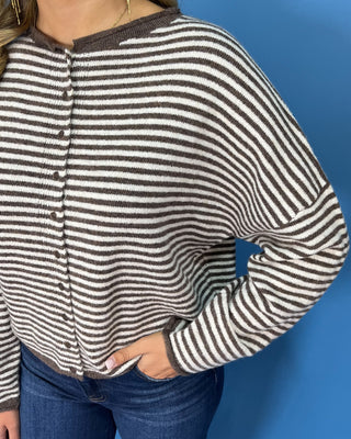 Chocolate brown and ivory striped knit cardigan with button-front detail, drop shoulders, long sleeves, and a relaxed fit.