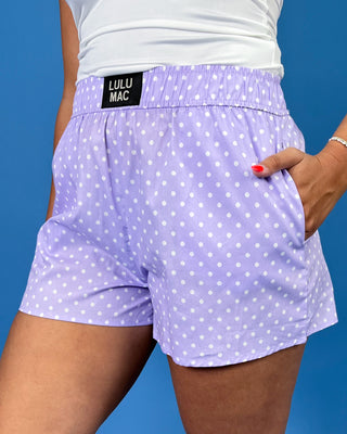 Lavender polka dot shorts with an elastic waistband and side pockets, shown on model.