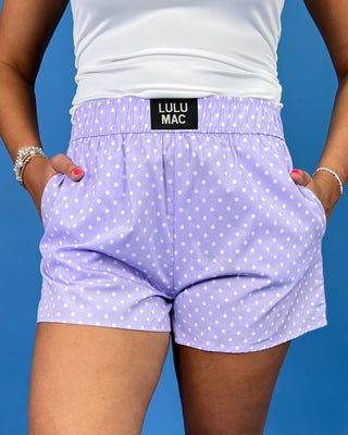 Lavender polka dot shorts with an elastic waistband and side pockets, shown on model.