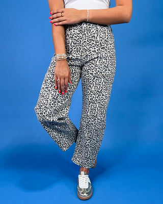 Gray leopard print barrel jeans with patch pockets, high-rise waist, and relaxed fit, shown on model.