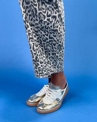 Gray leopard print barrel jeans with patch pockets, high-rise waist, and relaxed fit, shown on model.