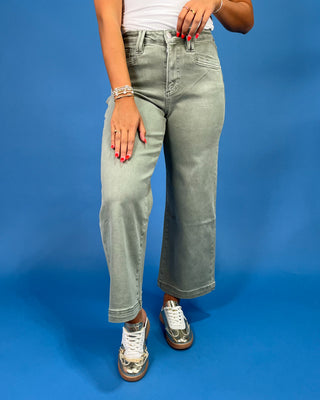 Light sage green wide leg jeans with a high-rise waist and relaxed fit, shown on model.