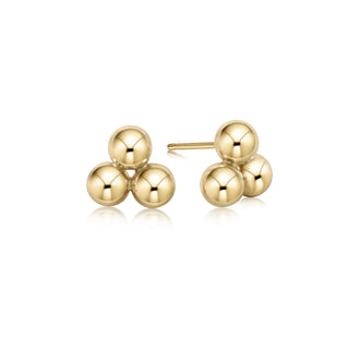 Pair of gold ball earrings on a white background