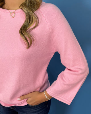 Soft pink long sleeve knit sweater with a crew neckline, relaxed fit, and classic everyday silhouette.
