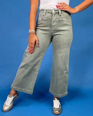 Light sage green wide leg jeans with a high-rise waist and relaxed fit, shown on model.