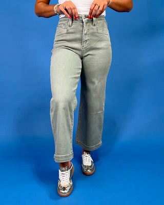 Light sage green wide leg jeans with a high-rise waist and relaxed fit, shown on model.