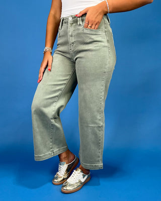 Light sage green wide leg jeans with a high-rise waist and relaxed fit, shown on model.