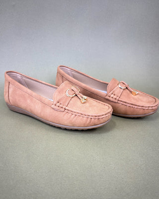 Pair of tan loafers on a gray background
