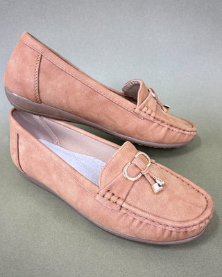 Pair of pink loafers with a decorative bow on a gray background