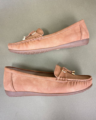 Pair of brown loafers on a gray background
