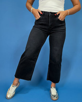 Black cropped wide leg jeans with a high-rise waist and raw hem, shown on model.