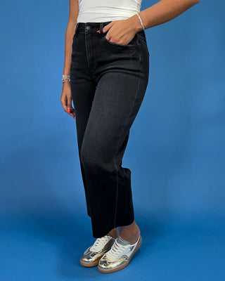 Black cropped wide leg jeans with a high-rise waist and raw hem, shown on model.