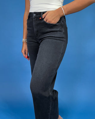 Black cropped wide leg jeans with a high-rise waist and raw hem, shown on model.