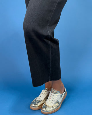 Black cropped wide leg jeans with a high-rise waist and raw hem, shown on model.