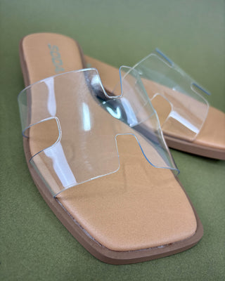 Tan sandal with clear visor on a green background
