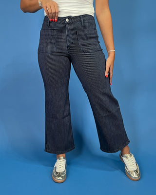 Dark wash pinstripe straight leg jeans with front patch pockets and a high-rise waist, shown on model.