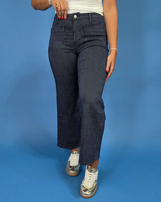 Dark wash pinstripe straight leg jeans with front patch pockets and a high-rise waist, shown on model.