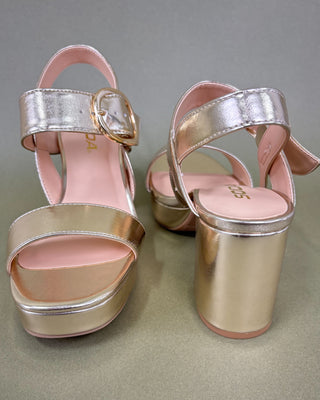 Gold and pink platform sandals on a gray background
