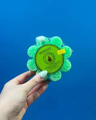 Spongellé Flower Body Wash Infused Buffer available in multiple fragrances, featuring a flower-shaped cleansing sponge infused with body wash and a convenient hanging ribbon.