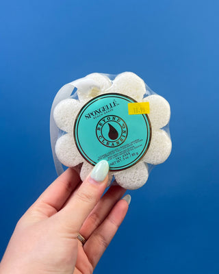 Spongellé Flower Body Wash Infused Buffer available in multiple fragrances, featuring a flower-shaped cleansing sponge infused with body wash and a convenient hanging ribbon.