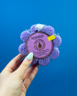 Spongellé Flower Body Wash Infused Buffer available in multiple fragrances, featuring a flower-shaped cleansing sponge infused with body wash and a convenient hanging ribbon.