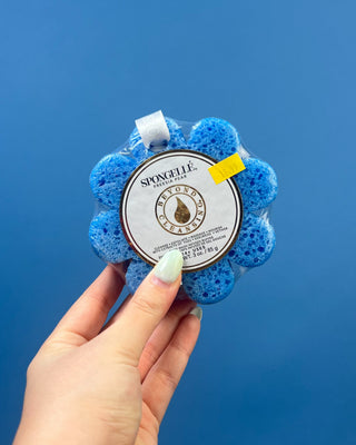Spongellé Flower Body Wash Infused Buffer available in multiple fragrances, featuring a flower-shaped cleansing sponge infused with body wash and a convenient hanging ribbon.