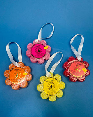 Spongellé Flower Body Wash Infused Buffer available in multiple fragrances, featuring a flower-shaped cleansing sponge infused with body wash and a convenient hanging ribbon.